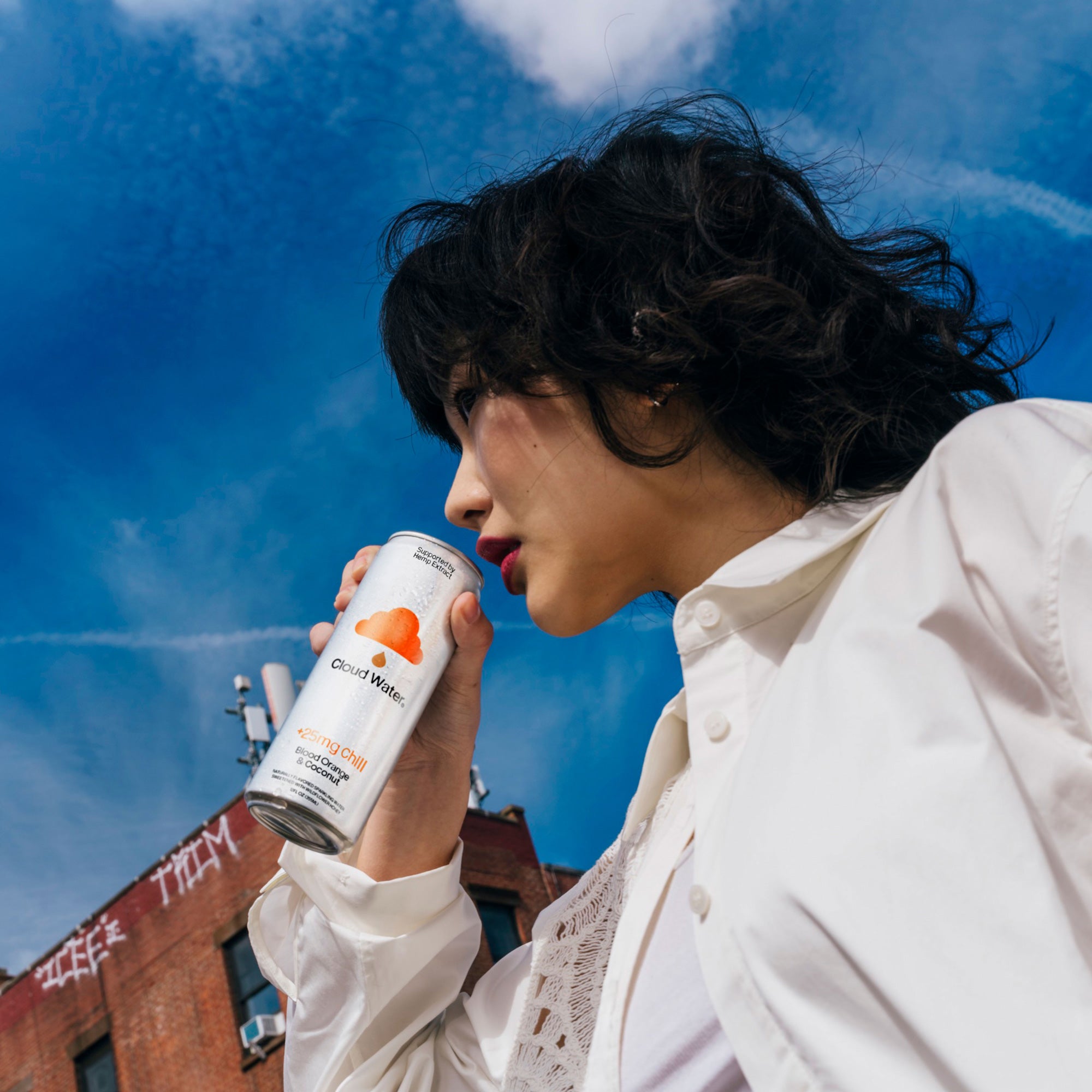 Girl enjoying the relaxing benefits of Cloud Water + Chill, hemp-infused sparkling seltzer