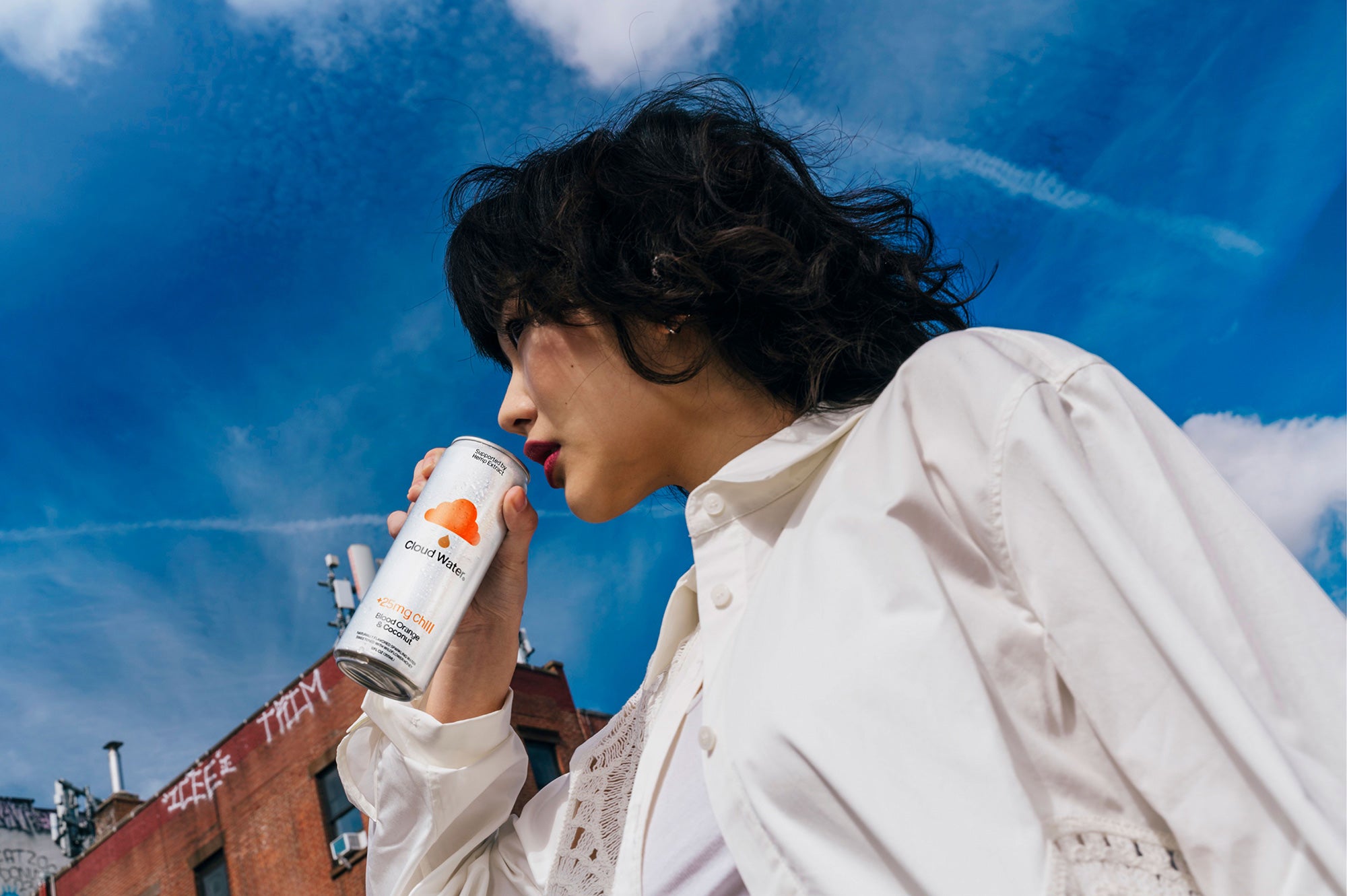 Girl enjoying the relaxing benefits of Cloud Water + Chill, hemp-infused sparkling seltzer